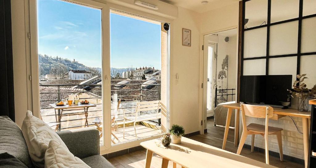 a living room with a view of a balcony at Balcon Vue Panoramique - Parking - Gare 200m in Vienne