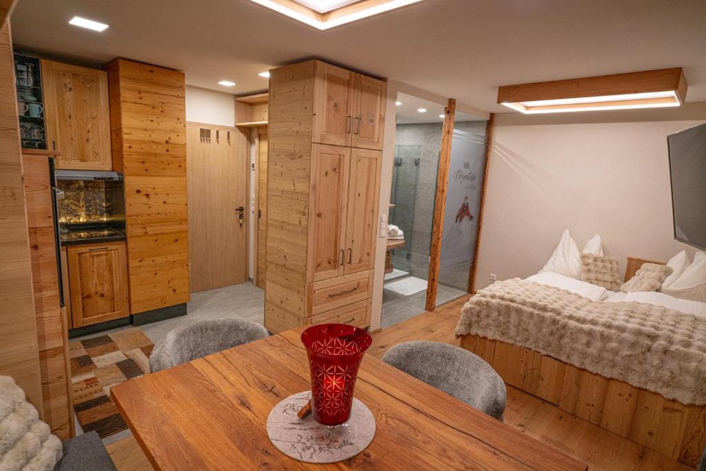 a bedroom with a bed and a table with a vase on it at Apart Alpin in Heiligenblut