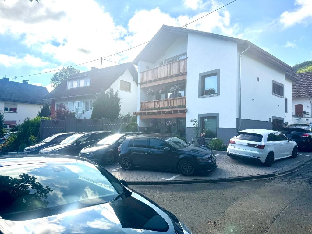 a parking lot with cars parked in front of a building at Apartment Nordschleife- Vina A3 in Quiddelbach