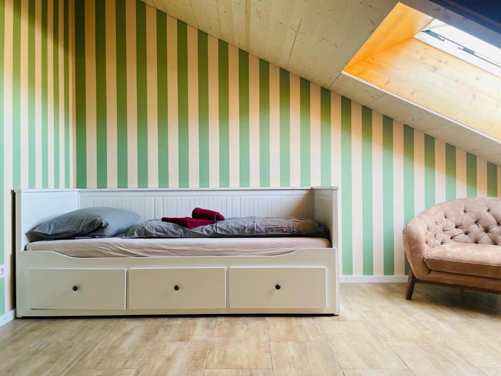 a bed in a room with green and white stripes at Das Vogelnest in Mössingen