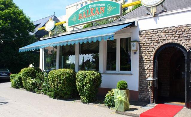 a restaurant with a sign on the front of it at Hotel Restaurant Balkan in Trier