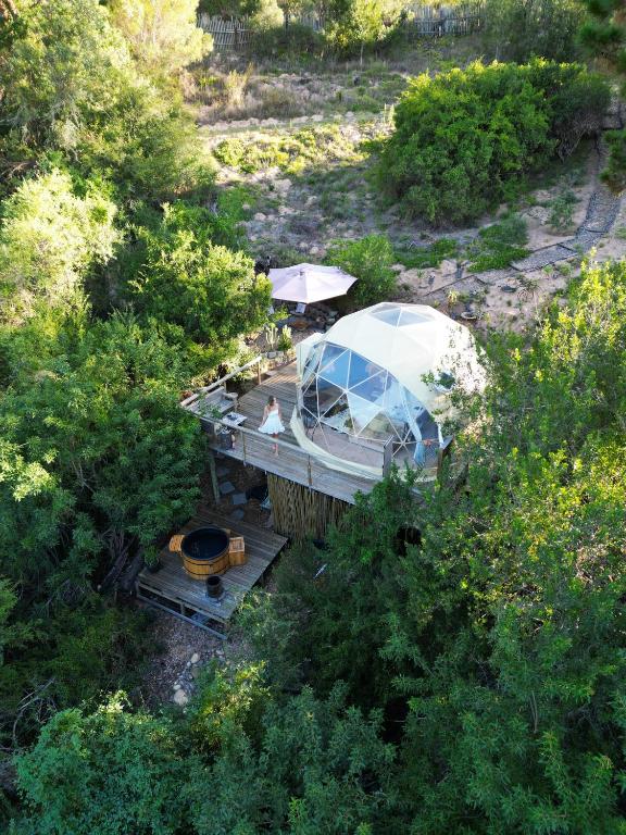 a boat on a bridge with a person on it at Soul Forest GeoDome - Off-grid Nature Escape in Sedgefield