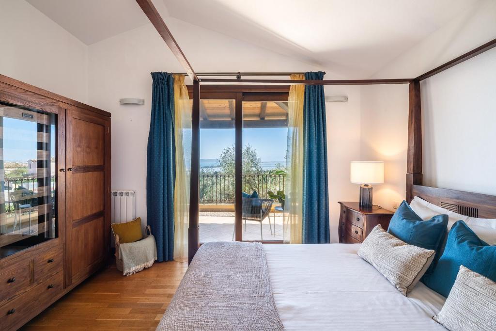 a bedroom with a bed and a sliding glass door at Cagliari Bay View Villa in Quartu Sant'Elena