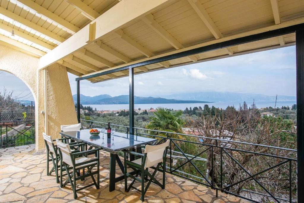 a patio with a table and chairs on a balcony at Nikiana Panorama in Nikiana
