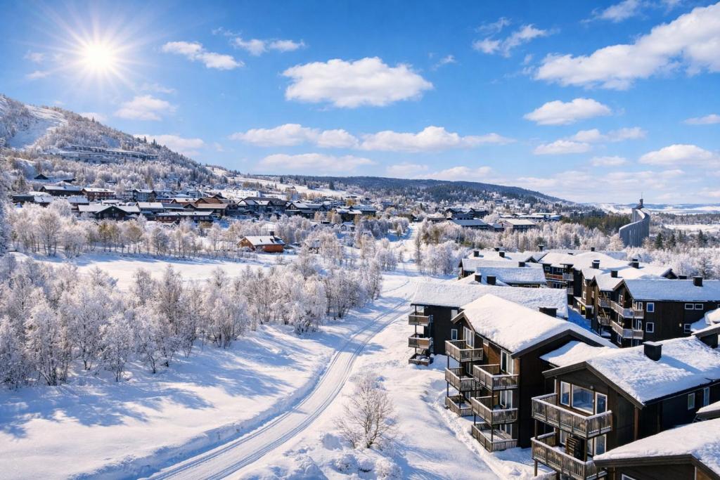 a city in the snow with buildings at Geilotunet Apartment - close to everything, free parking in garage, EV in Geilo