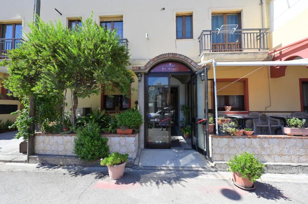 an entrance to a building with trees and plants at Camere da Angelo in Tortolì