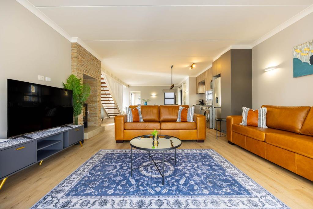 a living room with a couch and a table at Nova Haus in Plettenberg Bay