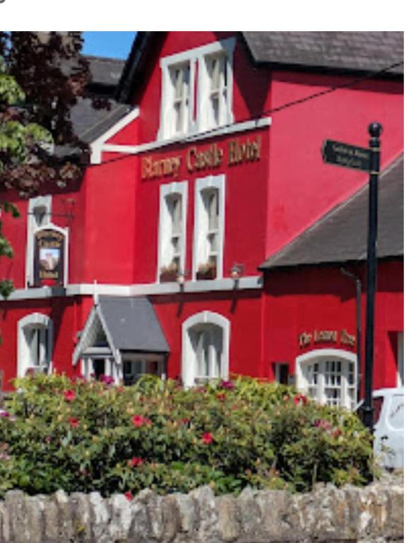 a red building with a happy cat bite written on it at Blarney Castle Hotel in Blarney