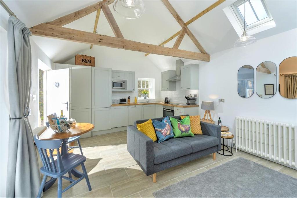 a living room with a couch and a table and a kitchen at 1 Bed in Lowick oc-coq46 in Holburn
