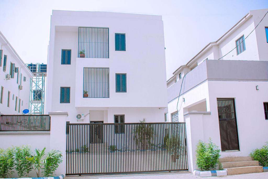 a white building with a gate in front of it at House 24 Jahi in Kadobunkuro