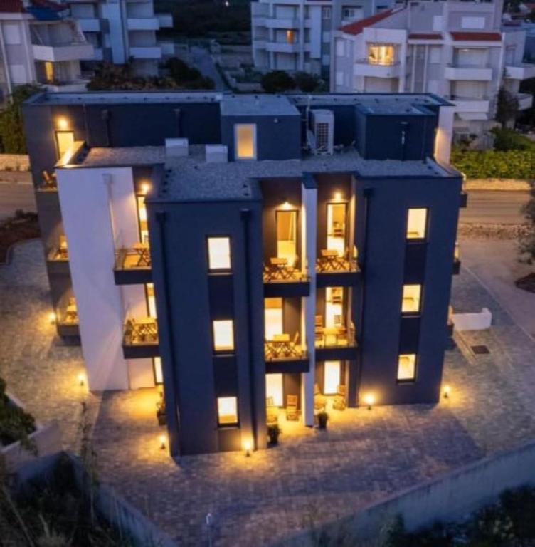 a large blue building with lights on it at night at The old man and the sea in Novalja