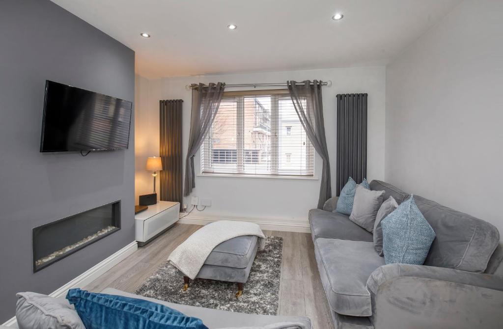 a living room with a couch and a flat screen tv at Holgate Lodge in York