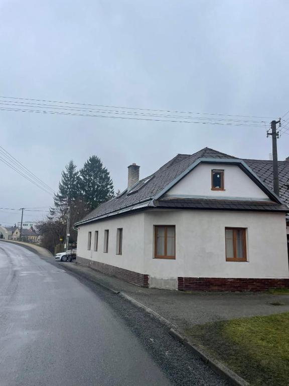 a white house sitting on the side of a street at Ubytování Jimramov in Jimramov