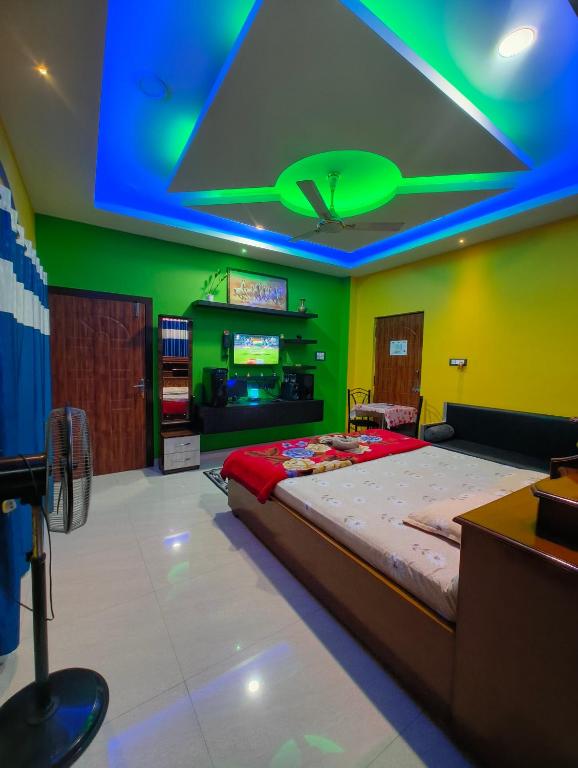 a bedroom with a large bed with a blue ceiling at Aashray Independent Homestay Dibrugarh in Dibrugarh