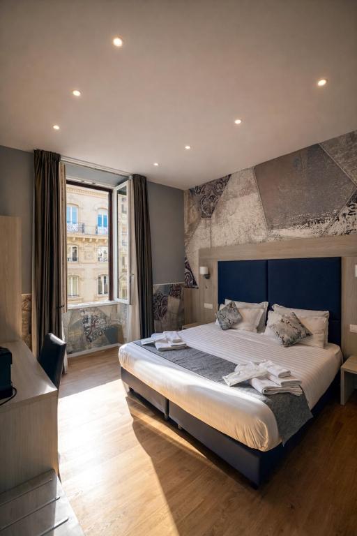 a bedroom with a large bed and a large window at Bramble Luxury Suites in Rome