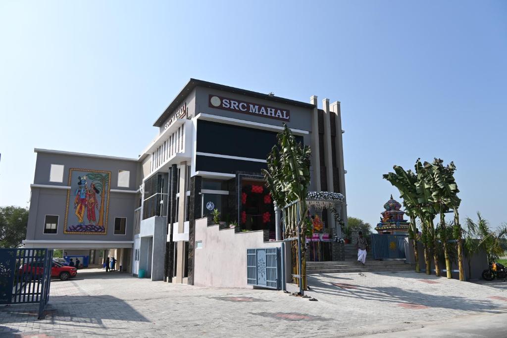 a building with a store on the side of it at SRC Mahal in Killai