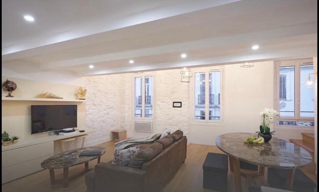 a living room with a couch and a table at Central luxury duplex in Cannes