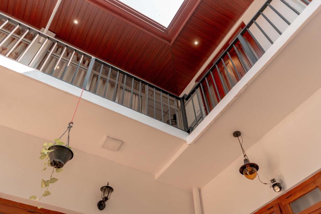 an attic room with a skylight and windows at Kandy Golden Gate Resort in Kandy