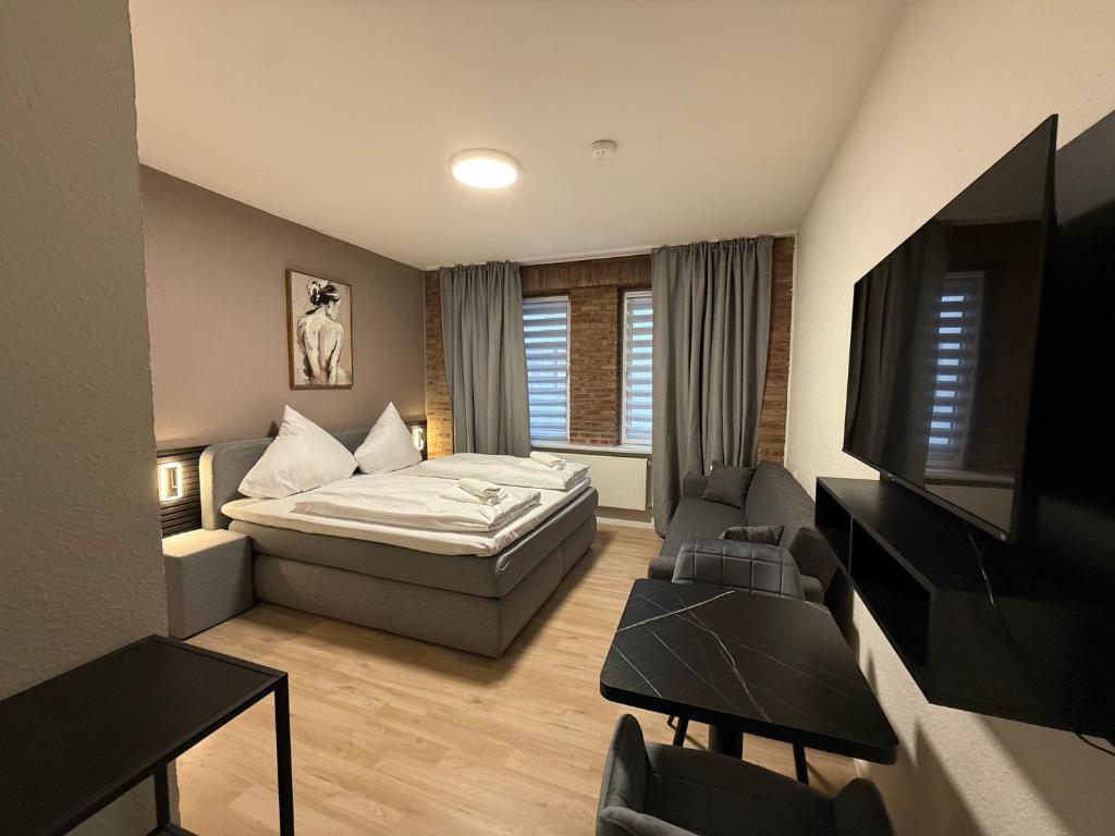a small room with a bed and a tv at Shin Central Self-Check-in in Essen