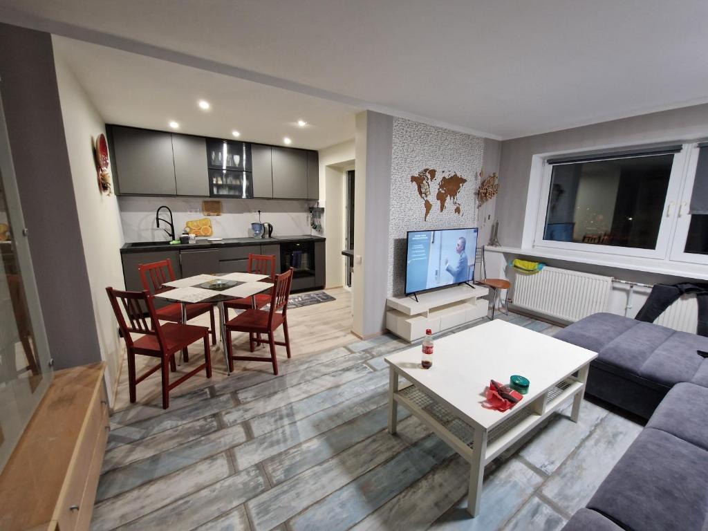 a living room with a couch and a table at Sitsi apartment in Tallinn