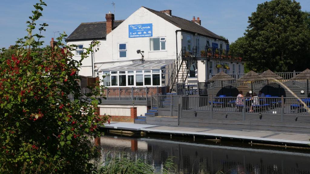 a white building with people standing in front of it at The Riverside in Spalding