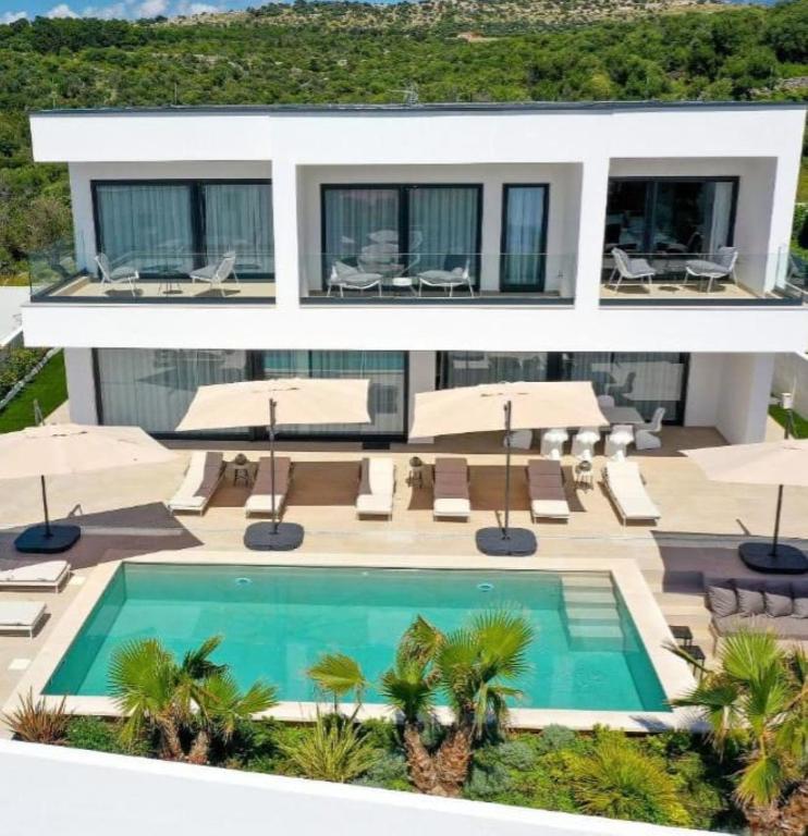 an image of a house with a swimming pool at Luxury Villa 360 - private heated pool in Novalja