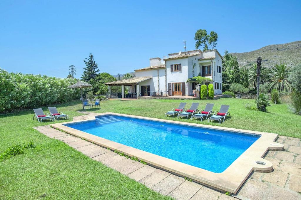 a swimming pool in front of a house at Villa Maina by Villa Plus in El Port