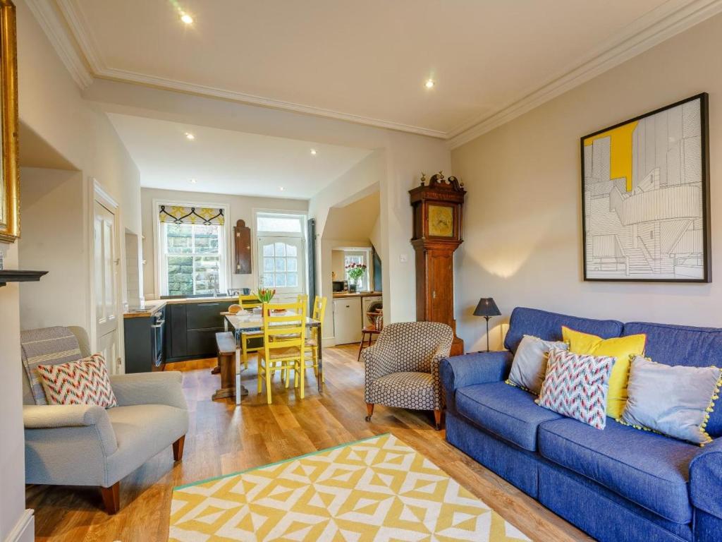 a living room with a blue couch and a table at 4 Bed in Harrogate oc-73424 in Harrogate