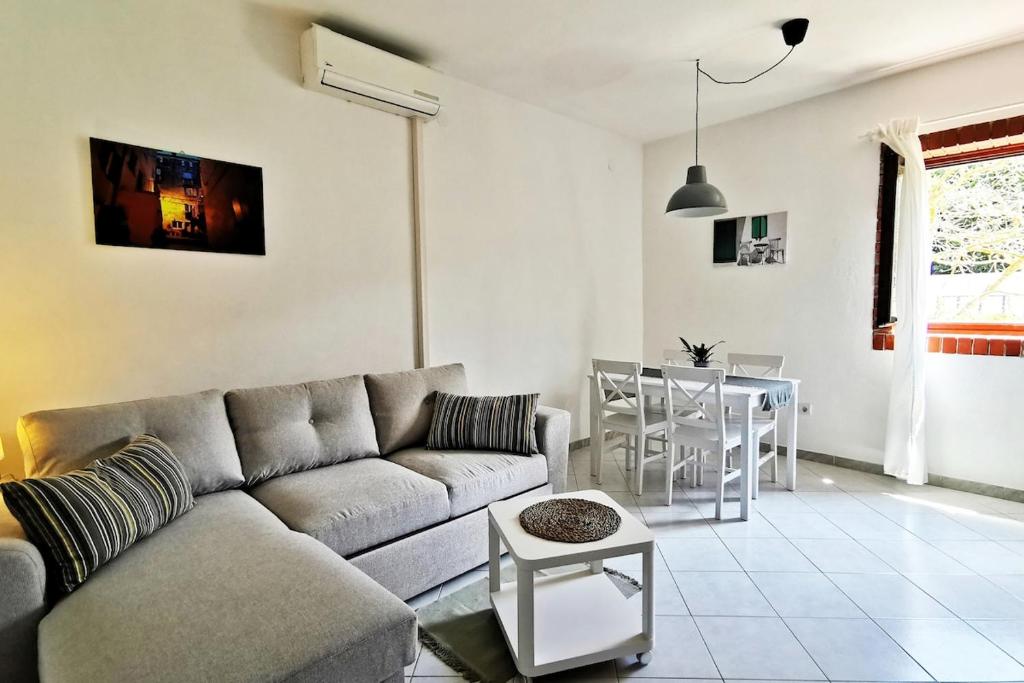 a living room with a couch and a table at Apartment Terrarossa 2 in Fažana
