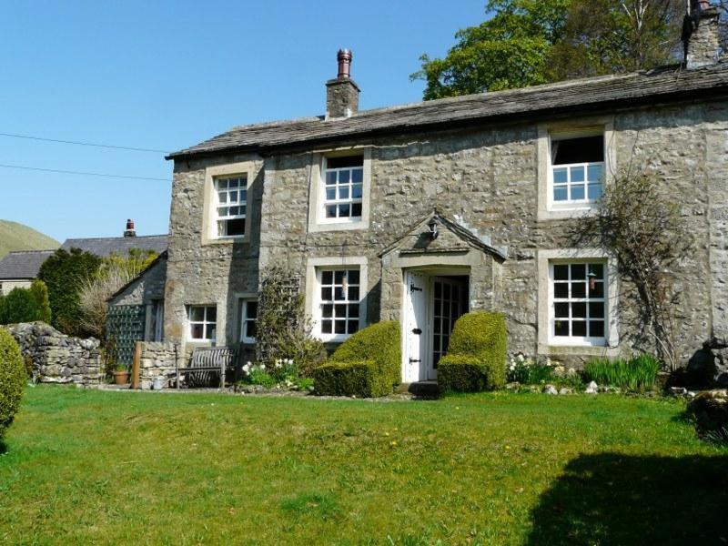 an old stone house with a grass yard at 4 Bed in Kettlewell oc-g0041 in Starbotton