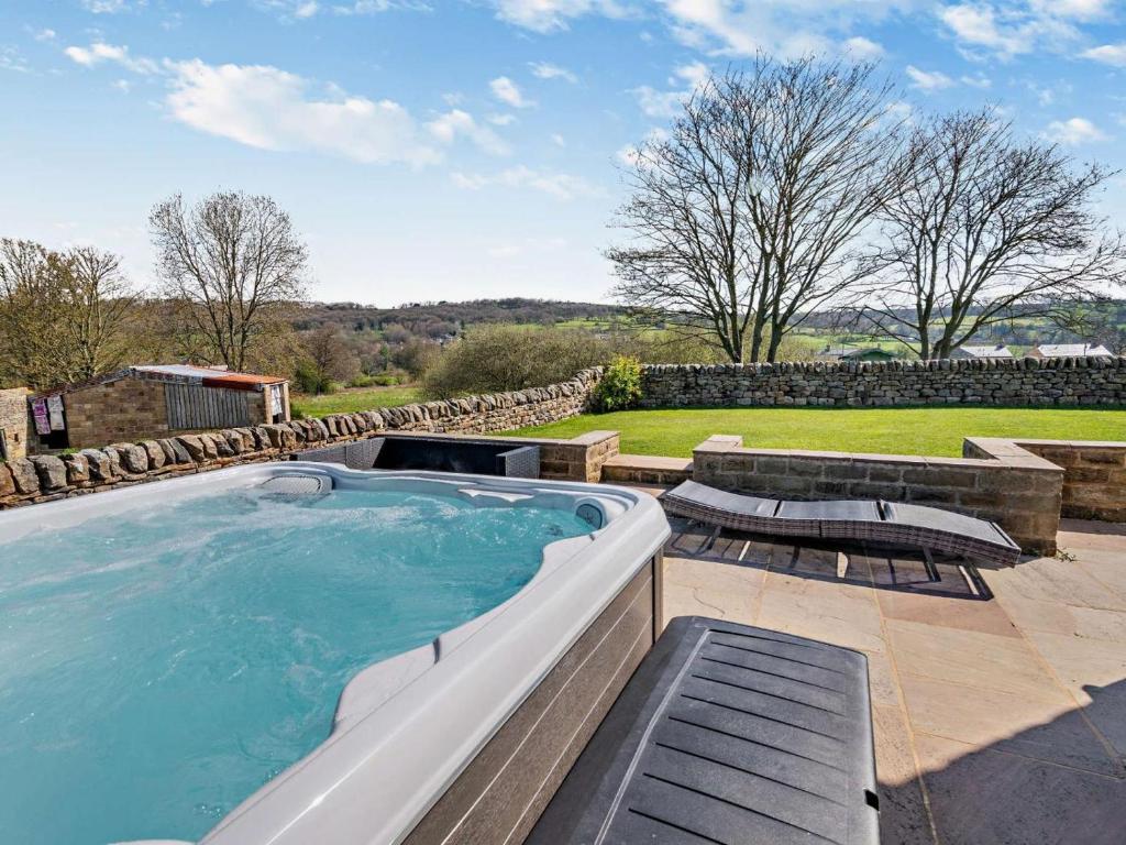 a large swimming pool with two chairs and a patio at 3 Bed in Harrogate oc-91269 in Summer Bridge
