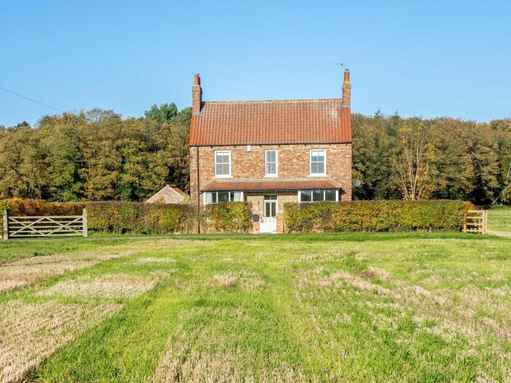 a large house with a grass field in front of it at 3 Bed in York oc-79525 in Deighton
