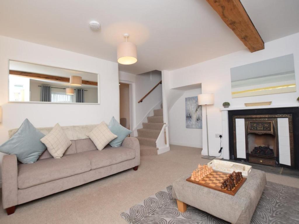 a living room with a couch and a fireplace at 2 Bed in Bideford oc-53994 in Appledore