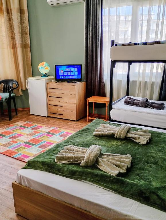 a bedroom with a bed with two pillows on it at GuestHouse 4 Karma369 in Plovdiv