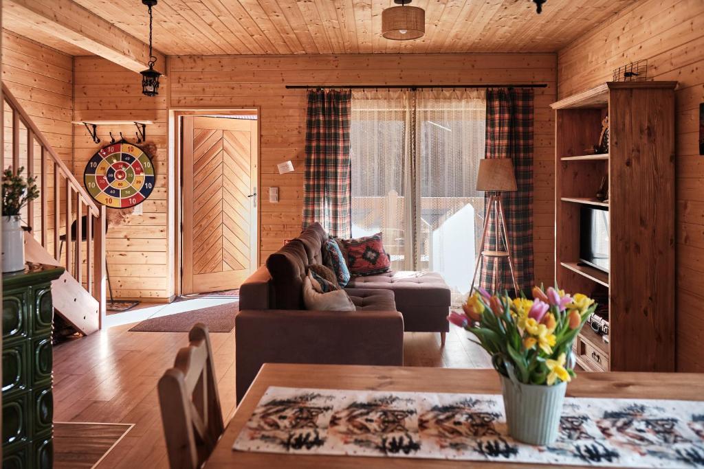 a living room with a couch and a table at Domek Sol Wilcza Zagroda in Kudowa-Zdrój