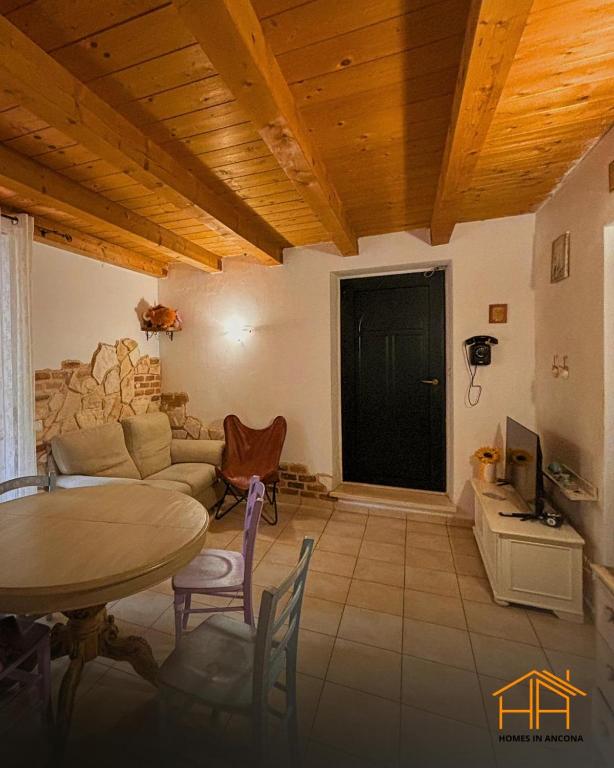 a living room with a table and a couch at La casa di Agnese by Homes in Ancona in Ancona