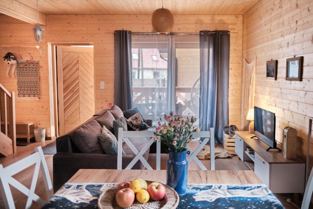 a living room with a couch and a table at Domek Luna Wilcza Zagroda in Kudowa-Zdrój