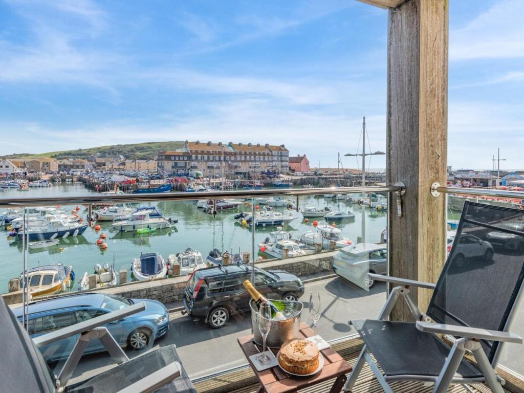 a balcony with a view of a marina with boats at 2 Bed in West Bay oc-dc065 in West Bay