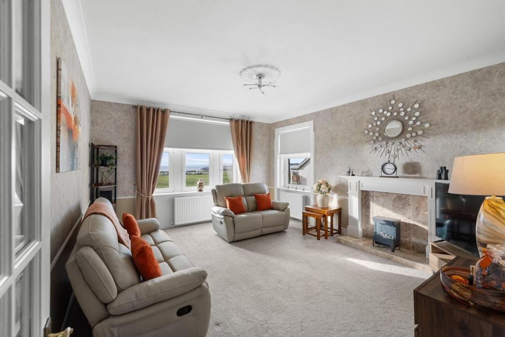 a living room with a couch and a fireplace at Birdies Nest in Carnoustie