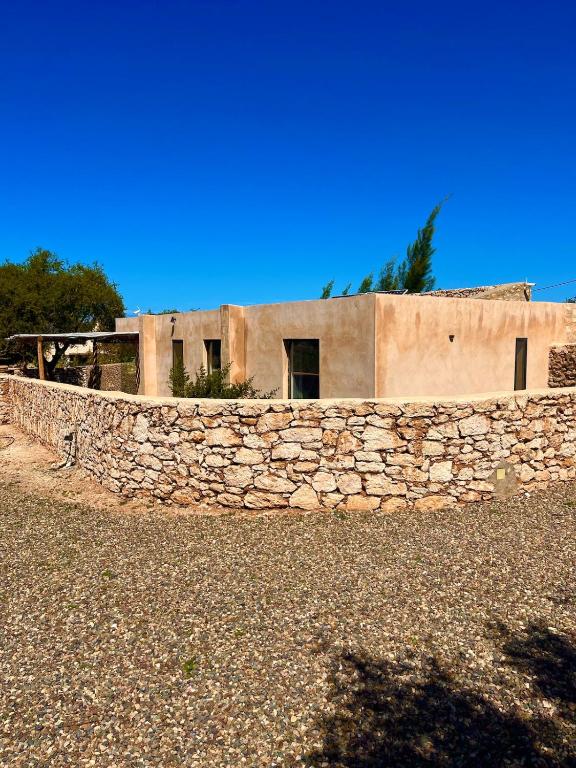 a stone wall in front of a building at Idyllic lodge in Essaouira