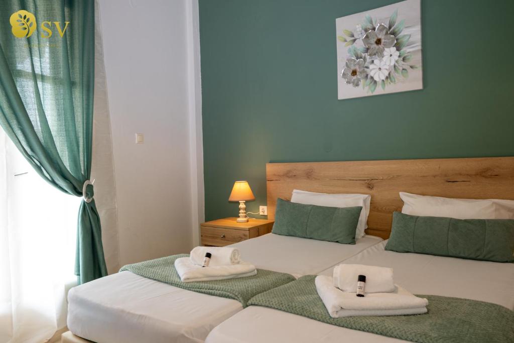a bedroom with two beds with towels on them at Secreta Vista in Kavos