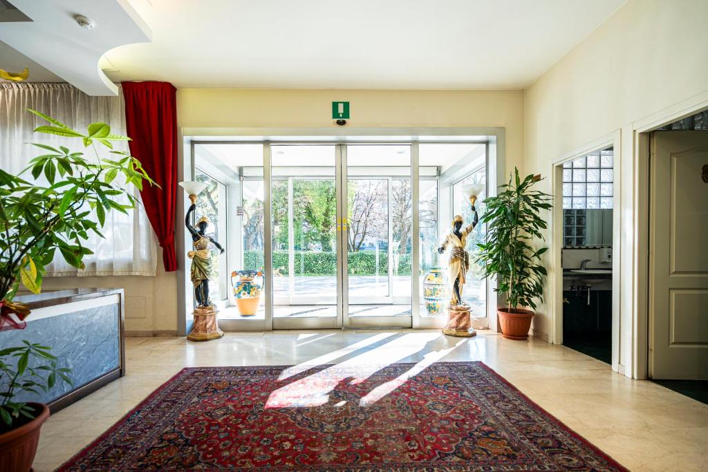 a lobby with a large glass door and plants at Venice Hotel Albatros in Mestre