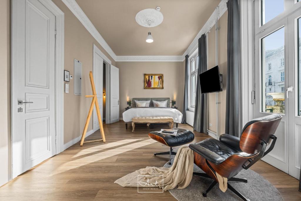 a bedroom with a bed and a chair at Art Apartments in Hamburg