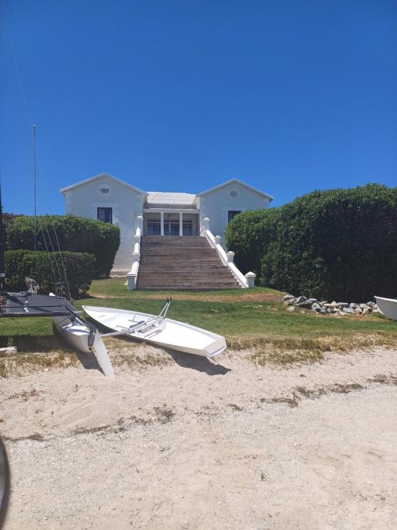 a house with two boats sitting on the beach at House with Those Stairs in Langebaan