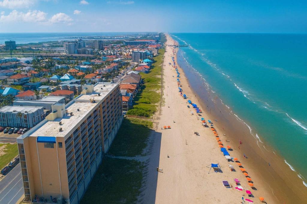 an overhead view of a beach with umbrellas and the ocean at Penthouse Beachfront Views Renovated condo in South Padre Island