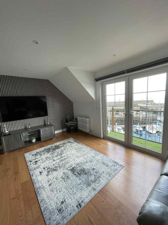 a living room with a television and a rug at Apartment in Banff in Banff