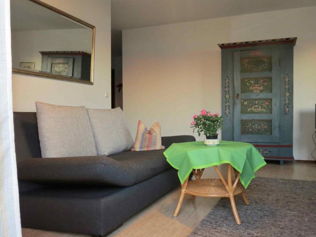 a living room with a couch and a table at Barrierefreie Ferienwohnung Bodenseeblick in Unteruhldingen