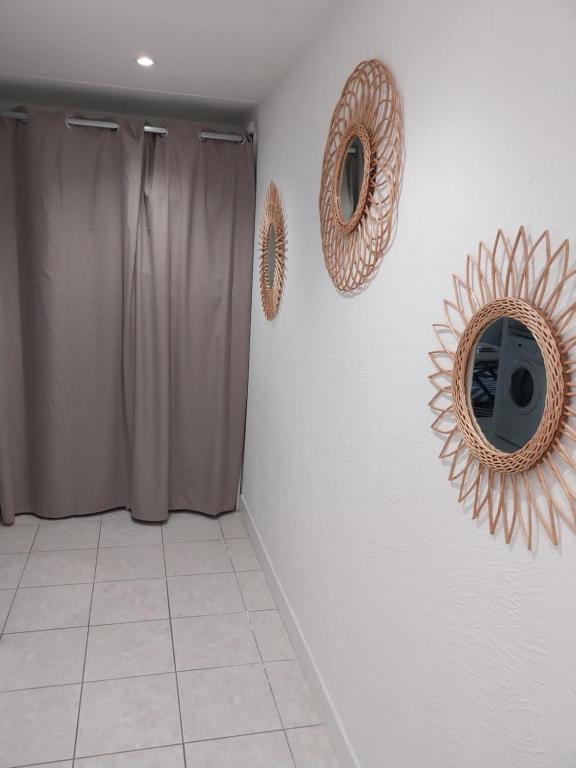 a bathroom with two mirrors on the wall and a shower at Menton 1 in Menton