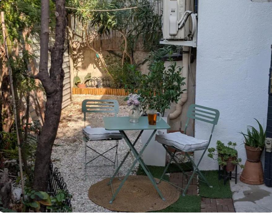 a table and two chairs sitting next to a building at La Perle in Marseille