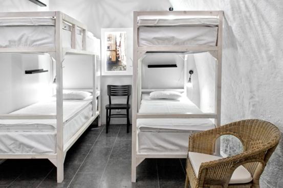 a room with two bunk beds and a chair at Old Town Hostel in Stockholm